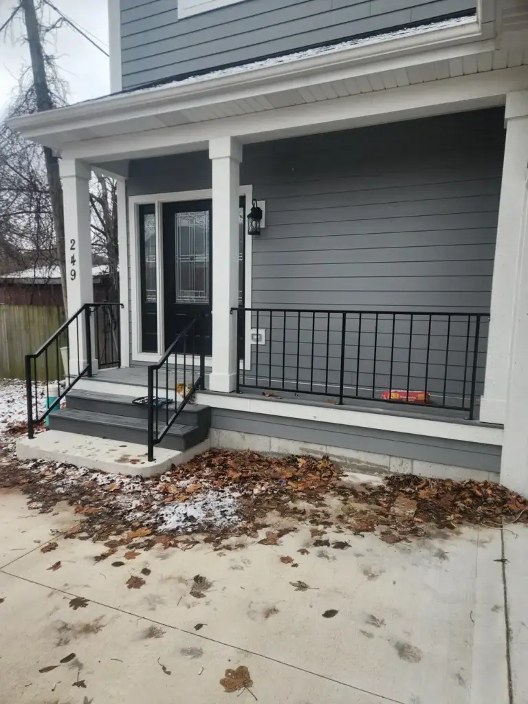 New wrought iron railing installed on a home's front steps